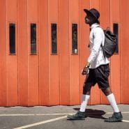 Man walking past a firestation by Clem Onojeghuo