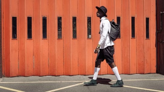 Man walking past a firestation by Clem Onojeghuo