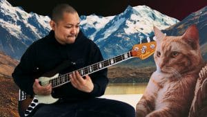 Posido Vega slapping the bass with a cat watching