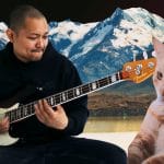 Posido Vega slapping the bass with a cat watching