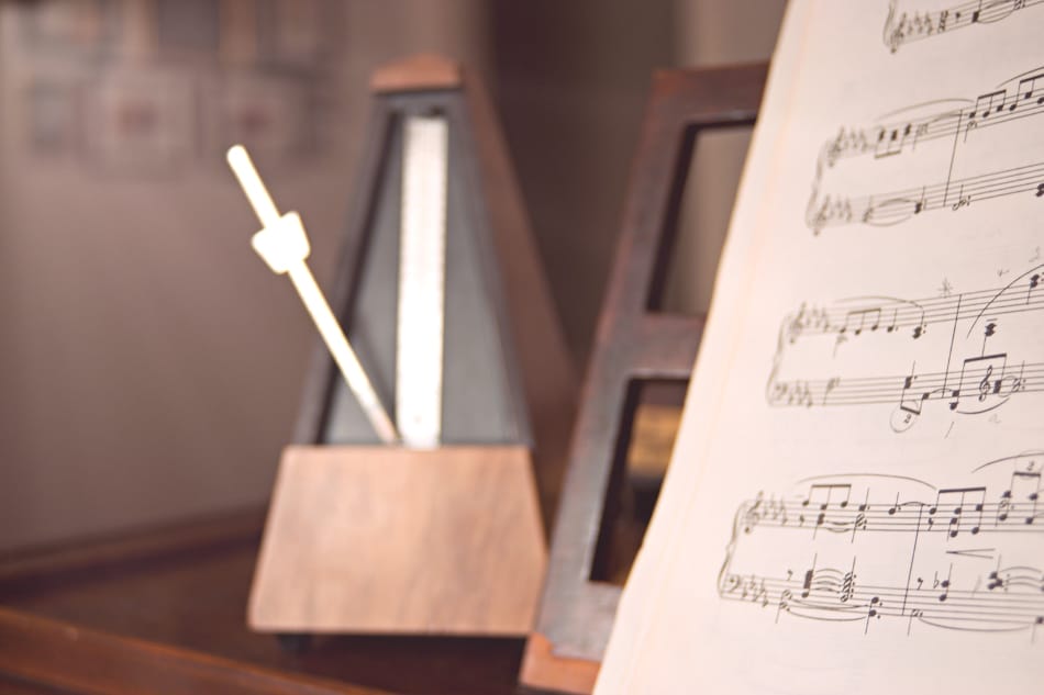 Practicing music to a metronome with sheet music