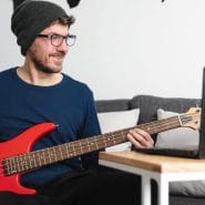 Best Apps For Practicing Jazz Improvisation - Man enjoying learning how to play the bass guitar