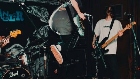 Make A Musician Website - Image of a band rocking out by Natalie Parham