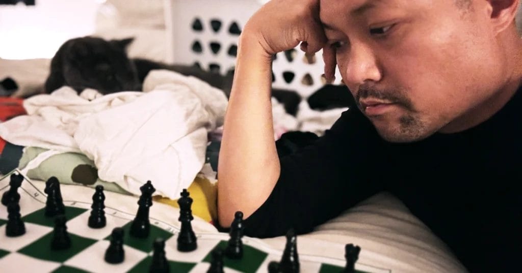 Posido Vega studying chess in bed