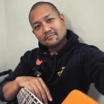 Posido Vega resting with bass guitar