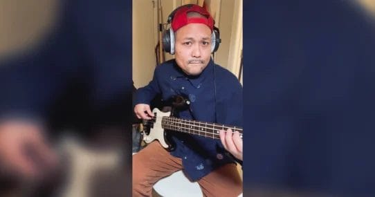 Posido Vega playing the bass with red hat