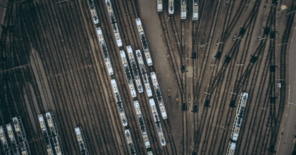 Trains in different tracks going in different directions - Image by Raymond Kotewicz