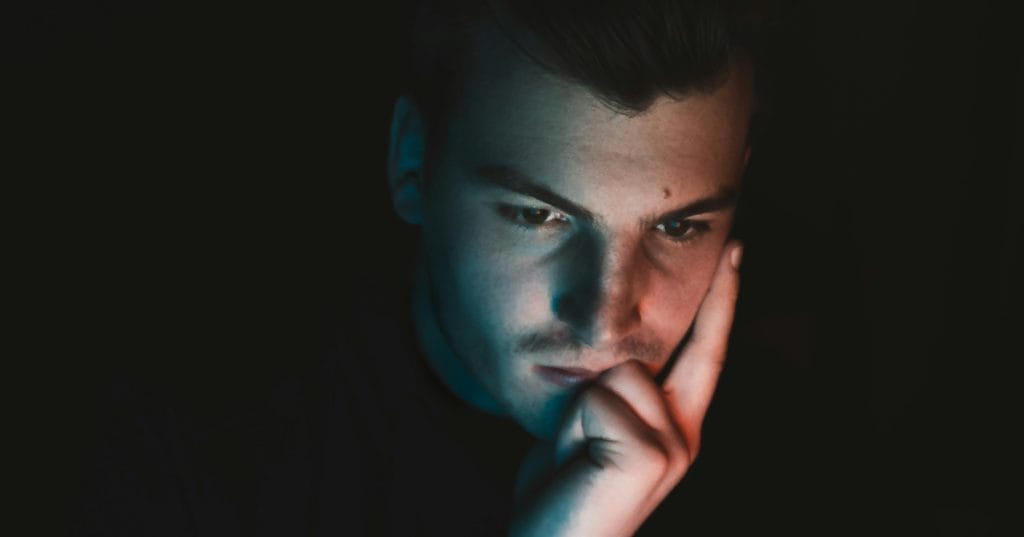 Person with hand on face thinking about a decision - Image by Lorenz Lippert